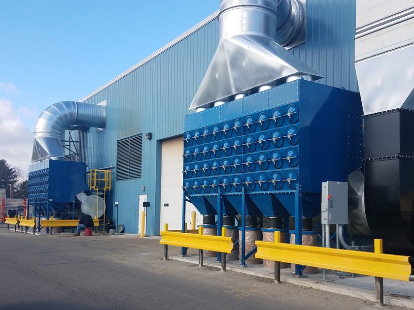 Industrial cartridge dust collection system installed outside a manufacturing facility
