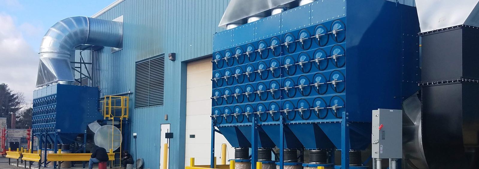 Industrial dust collection system outside a manufacturing facility